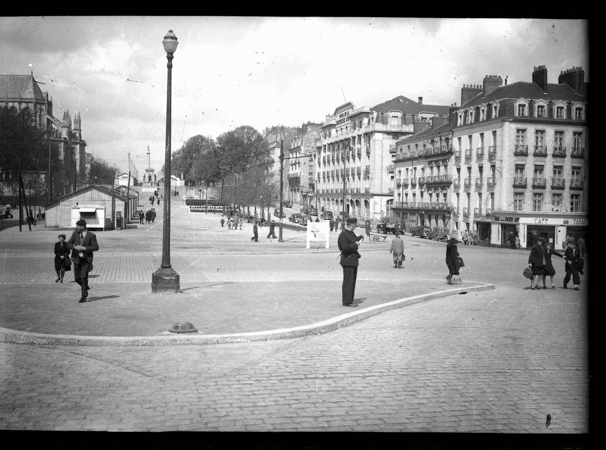 Après la libération de Nantes, des baraquements sont installés sur la place de la Duchesse-Anne pour servir de magasins provisoires aux commerçants qui ont vu leurs locaux détruits par les bombardements alliés durant la Seconde Guerre mondiale (10Fi396)